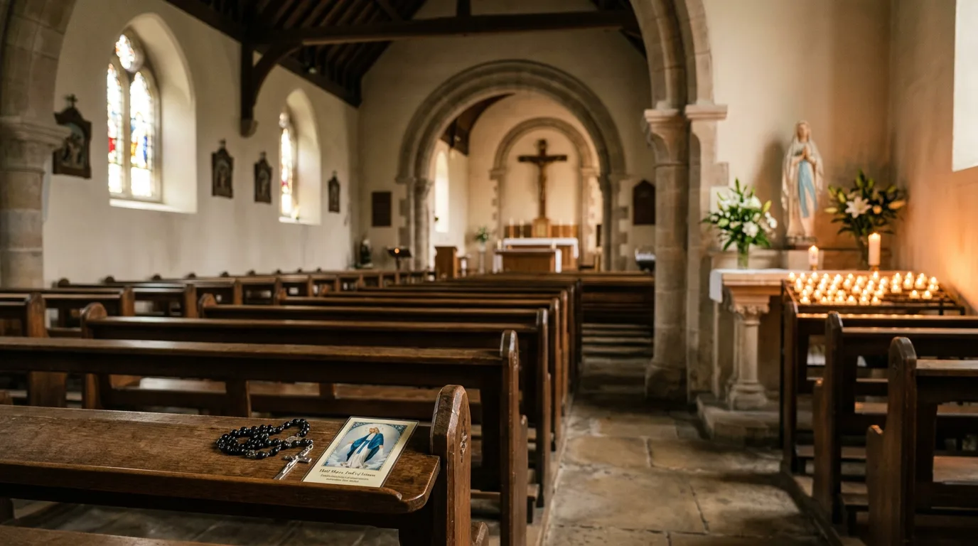 Quiet candlelit Catholic chapel with a holy card and rosary